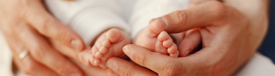 Parents with daughter. Family in a park. Newborn girl.