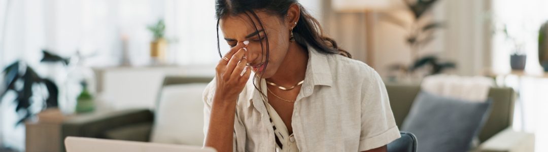 Woman, headache and work from home stress on laptop for marketing mistake, copywriting fail or onli.